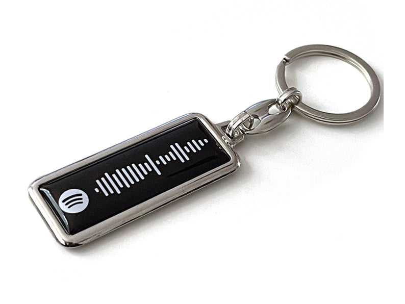 Zwarte Spotify sleutelhanger met gepersonaliseerde songcode. Perfect cadeau voor muziekliefhebbers. Scan en speel jouw favoriete nummer direct af.