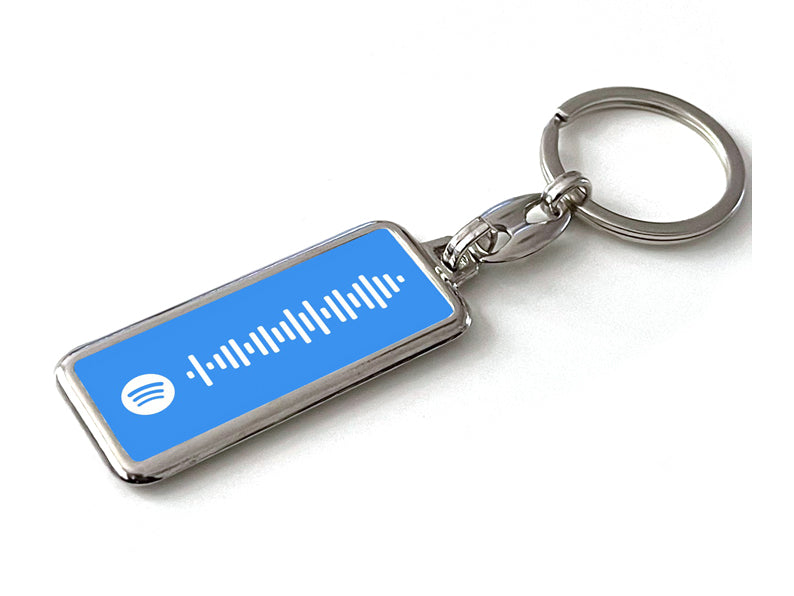 Gepersonaliseerde blauwe Spotify sleutelhanger met unieke songcode. Perfect als cadeau of accessoire voor muziekliefhebbers. Scan en speel jouw nummer af!