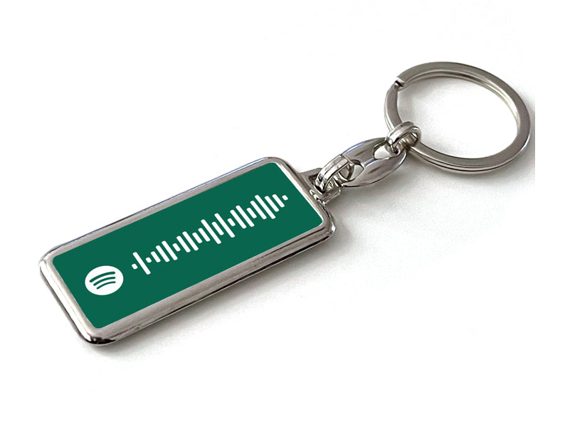 Gepersonaliseerde Spotify sleutelhanger met groene achtergrond en scanbare Spotify code. Uniek cadeau voor muziekliefhebbers of als persoonlijk accessoire.