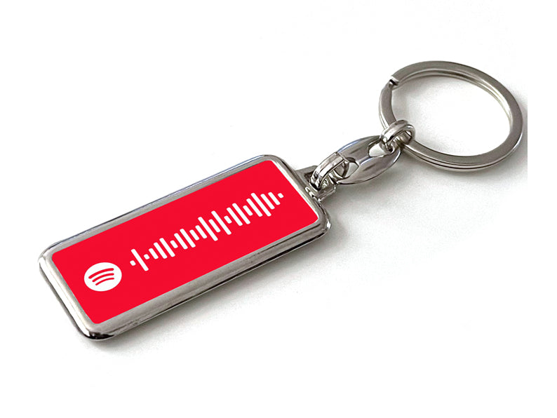 Gepersonaliseerde rode Spotify sleutelhanger met scanbare code. Uniek muziekcadeau voor muziekliefhebbers of als persoonlijk accessoire.